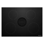 Sleek black induction cooktop with four cooking zones and integrated downdraft vent for modern kitchen appliances collection