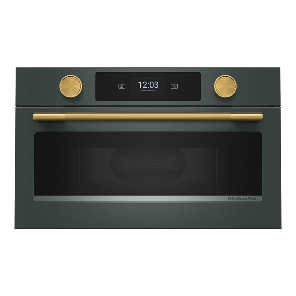 Built-in dark gray microwave with gold knobs and handle, digital display, part of KitchenAid appliances collection