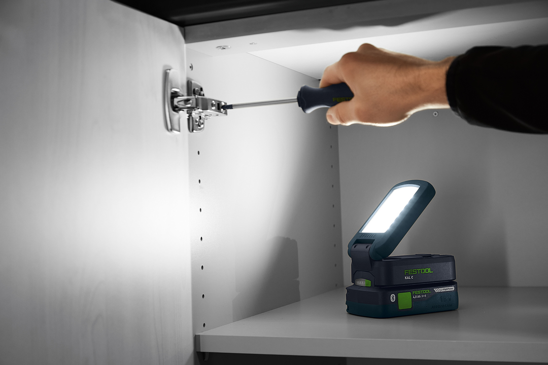 Cordless task light with bright LED panel illuminating a cabinet interior during home improvement work under $100