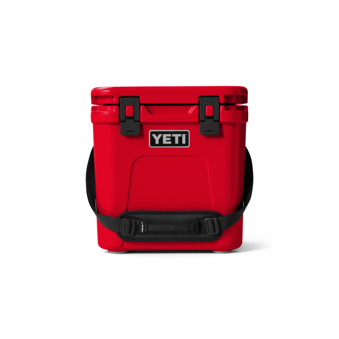 Red durable YETI cooler with secure latches and padded shoulder strap for food storage and organization collections