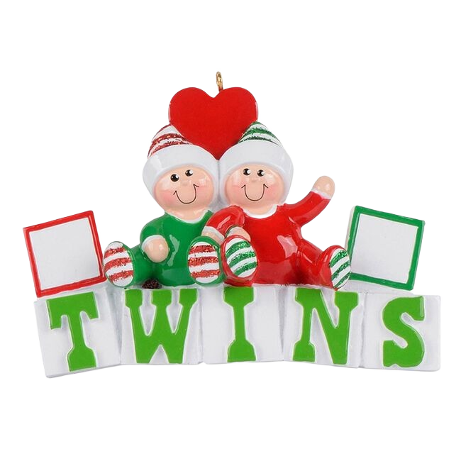 Pair of smiling twins in red and green outfits sitting above green letter blocks spelling TWINS, Christmas Ornament under $50 collection