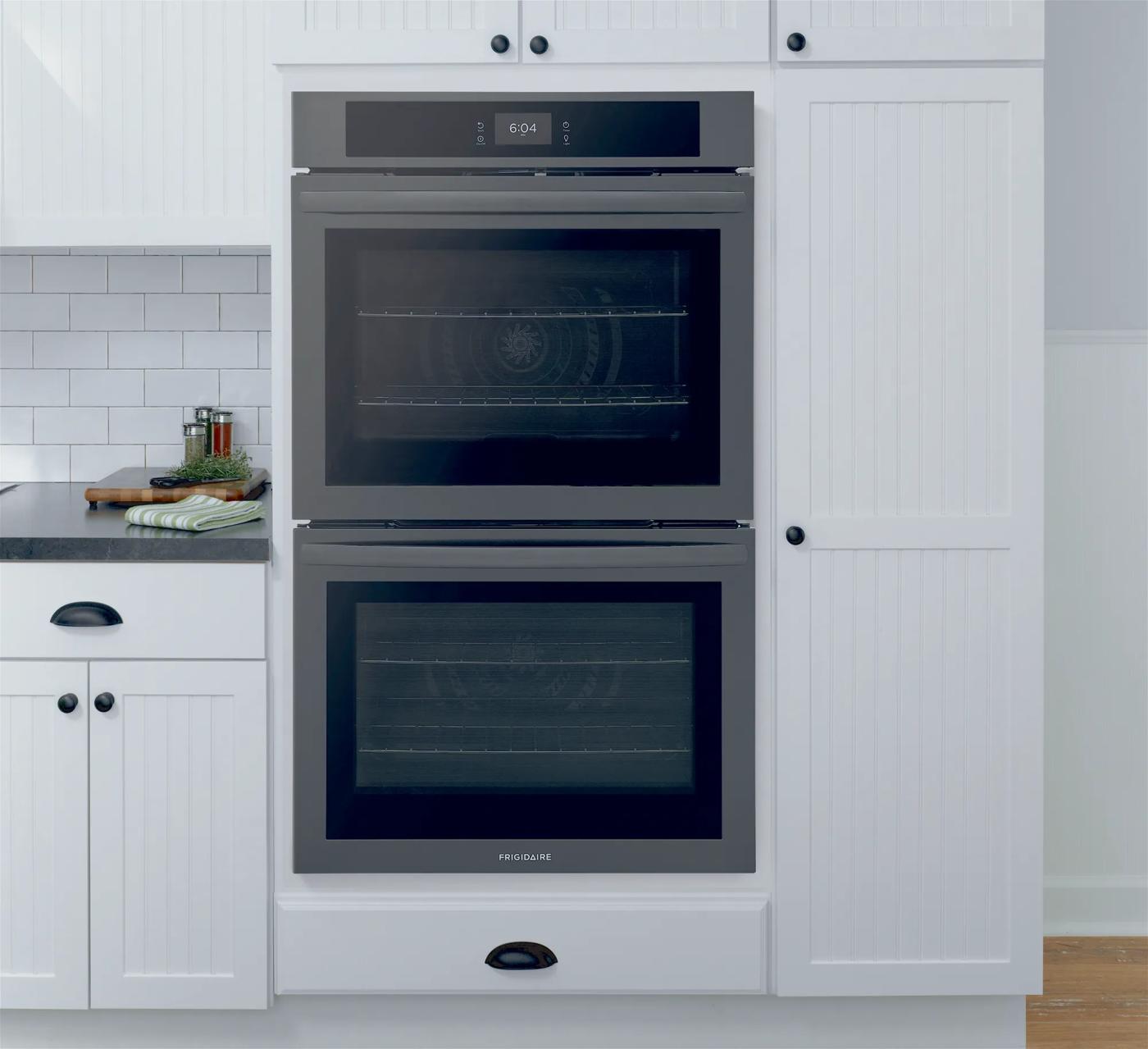 Built-in double electric oven with fan convection in a white kitchen setting for wall oven appliance collection.