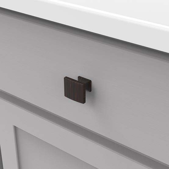 Square vintage bronze cabinet knob with a subtle forged look installed on a gray cabinet drawer front