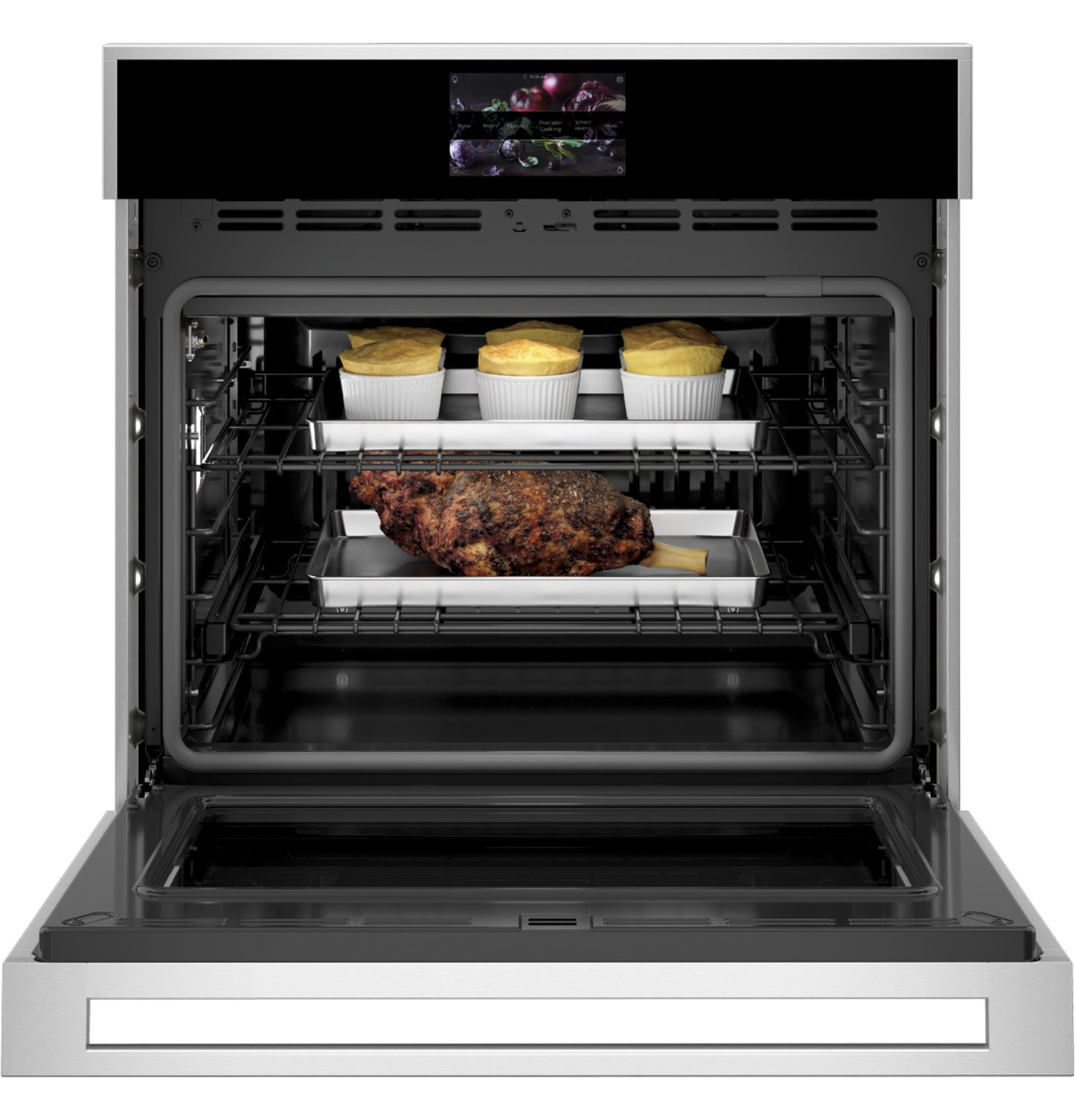 Open minimalist wall oven with stainless steel trim baking meat and soufflés inside in Appliances collection