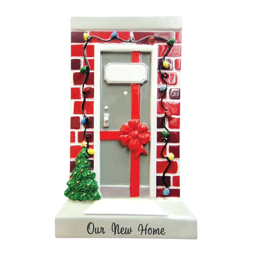 Christmas ornament shaped like a decorated front door with brick wall, holiday lights, tree, and "Our New Home" text below