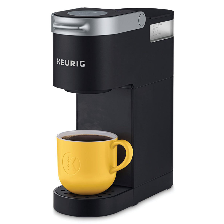 Black compact single-serve coffee maker brewing into a yellow ceramic mug with a modern, minimalist design