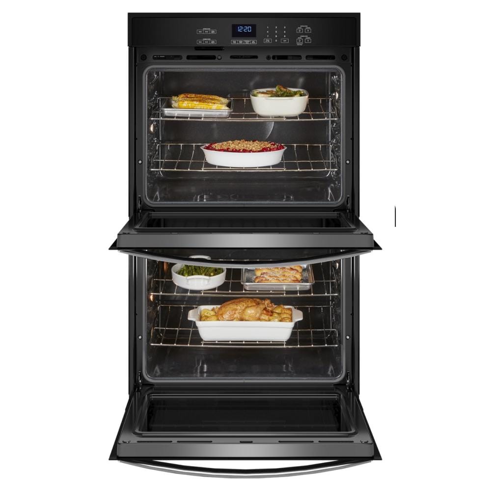 Open double wall oven from appliances collection showing multiple dishes cooking on racks inside both chambers