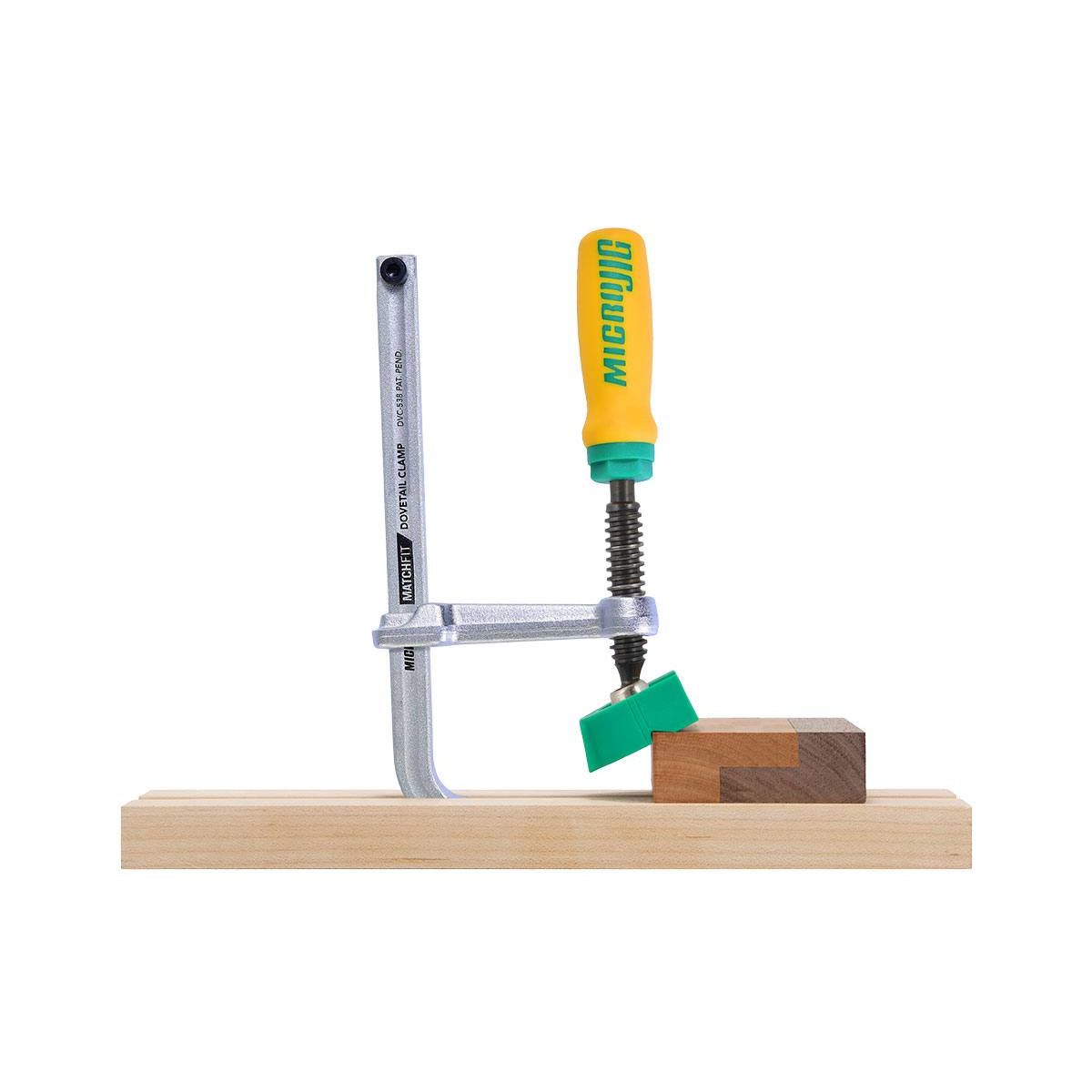 Metal and plastic clamp with ergonomic handle securing wooden pieces for woodworking and power tool accessories under $50 category