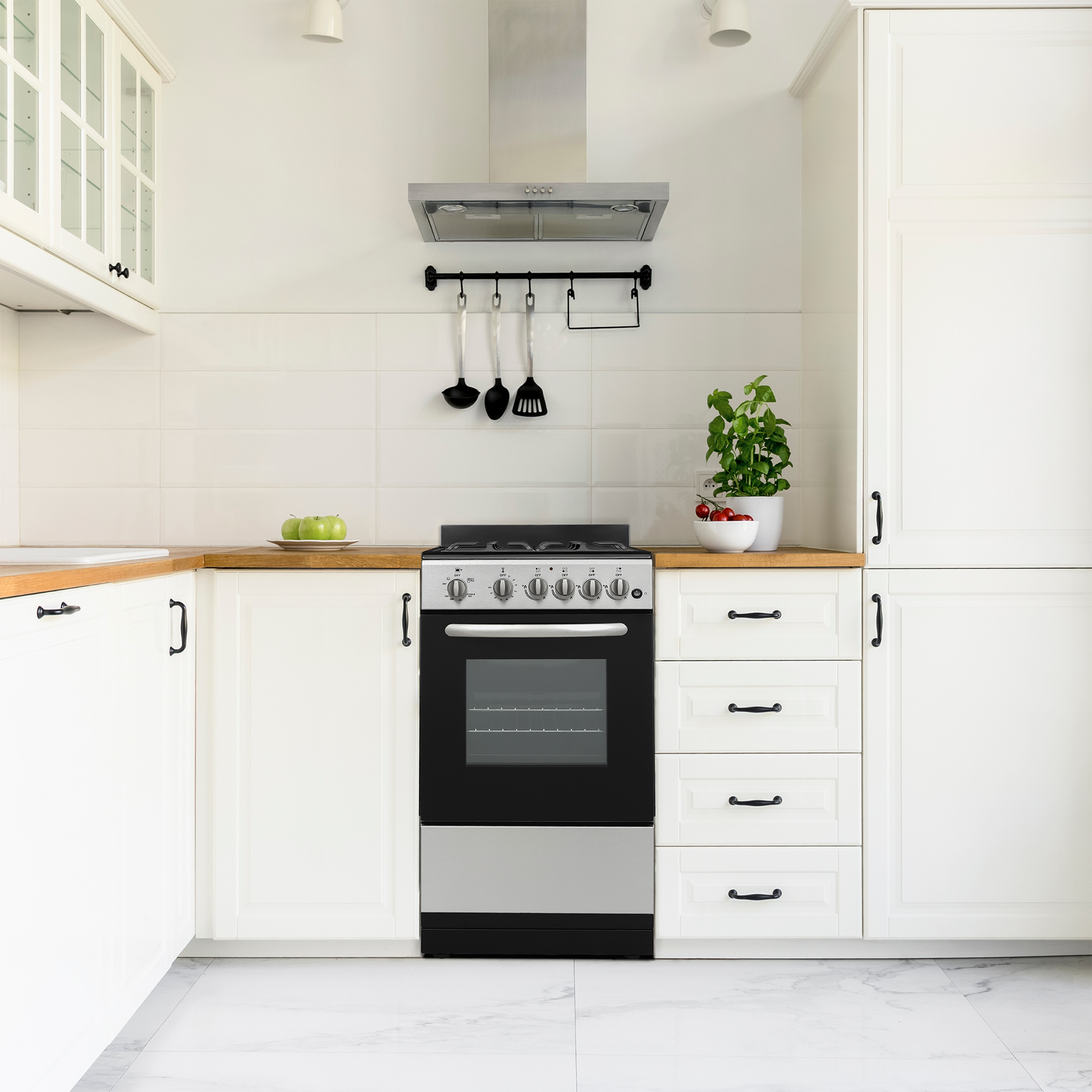 Modern black and stainless steel gas range with control knobs, oven window, set in bright white kitchen cabinetry and countertop