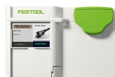 Close-up of white and green modular Festool storage box with customizable label for workshop organization