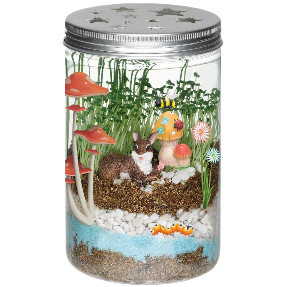 Miniature garden terrarium with bunny figure, mushrooms, flowers, and layered soil inside a mason-style jar for outdoor living decor