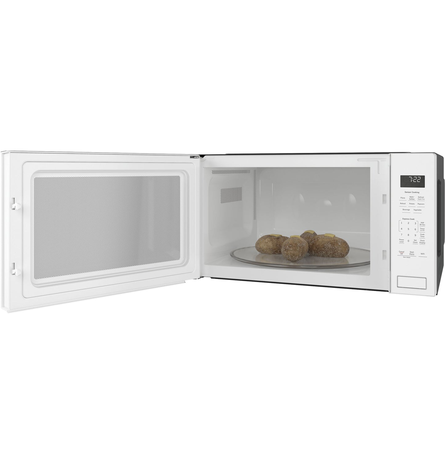 White built-in microwave oven with digital control panel and cooking potatoes on a rotating glass tray inside
