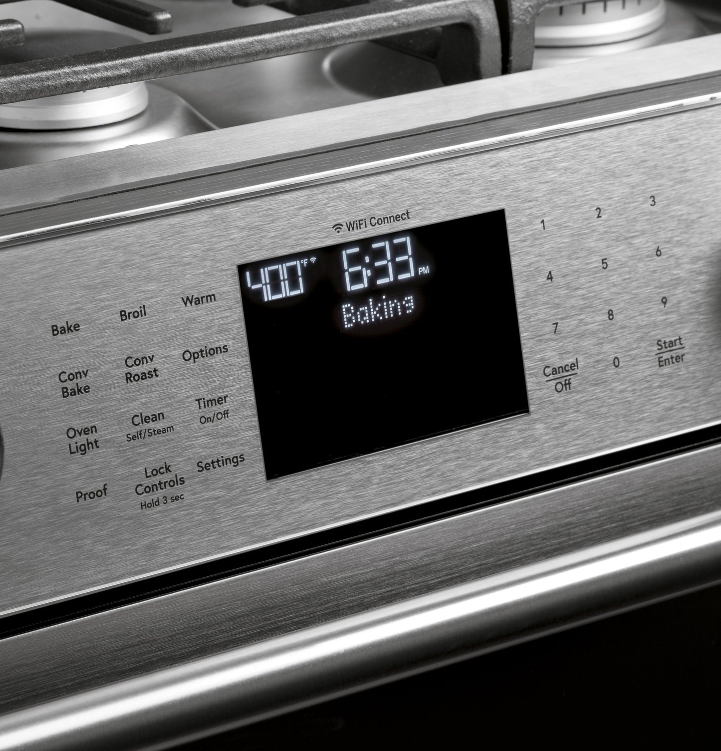 Close-up of stainless steel smart gas range control panel with digital display and touchscreen controls for baking timer
