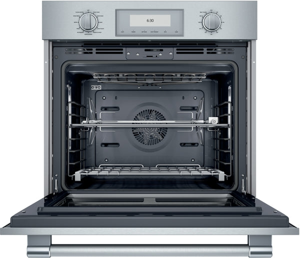 Open stainless steel oven interior with racks and dual control knobs for Thermador kitchen appliances collection