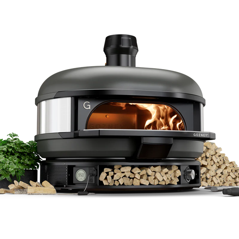 Black outdoor pizza oven with digital controls, wood storage, and visible fire for grilling in outdoor living spaces