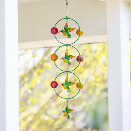 Decorative three tiered hummingbird twirler with colorful metal birds and orbs for outdoor home improvement spaces