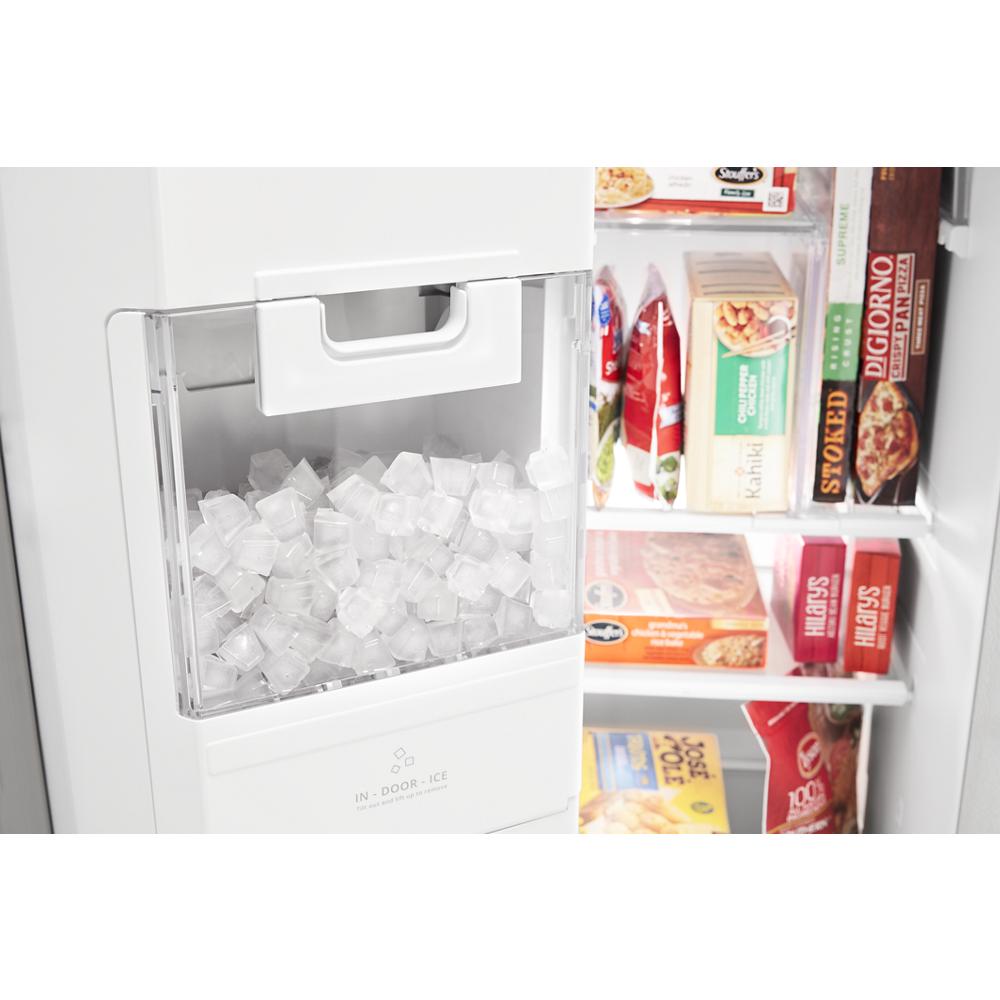 Clear ice bin filled with cubed ice inside a 36-inch side-by-side refrigerator in kitchen appliances collection