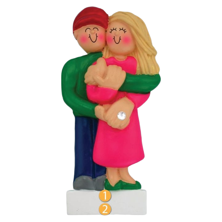 Blonde female figurine in pink dress embraced by man in green shirt holding hands with engagement ring for Christmas decor