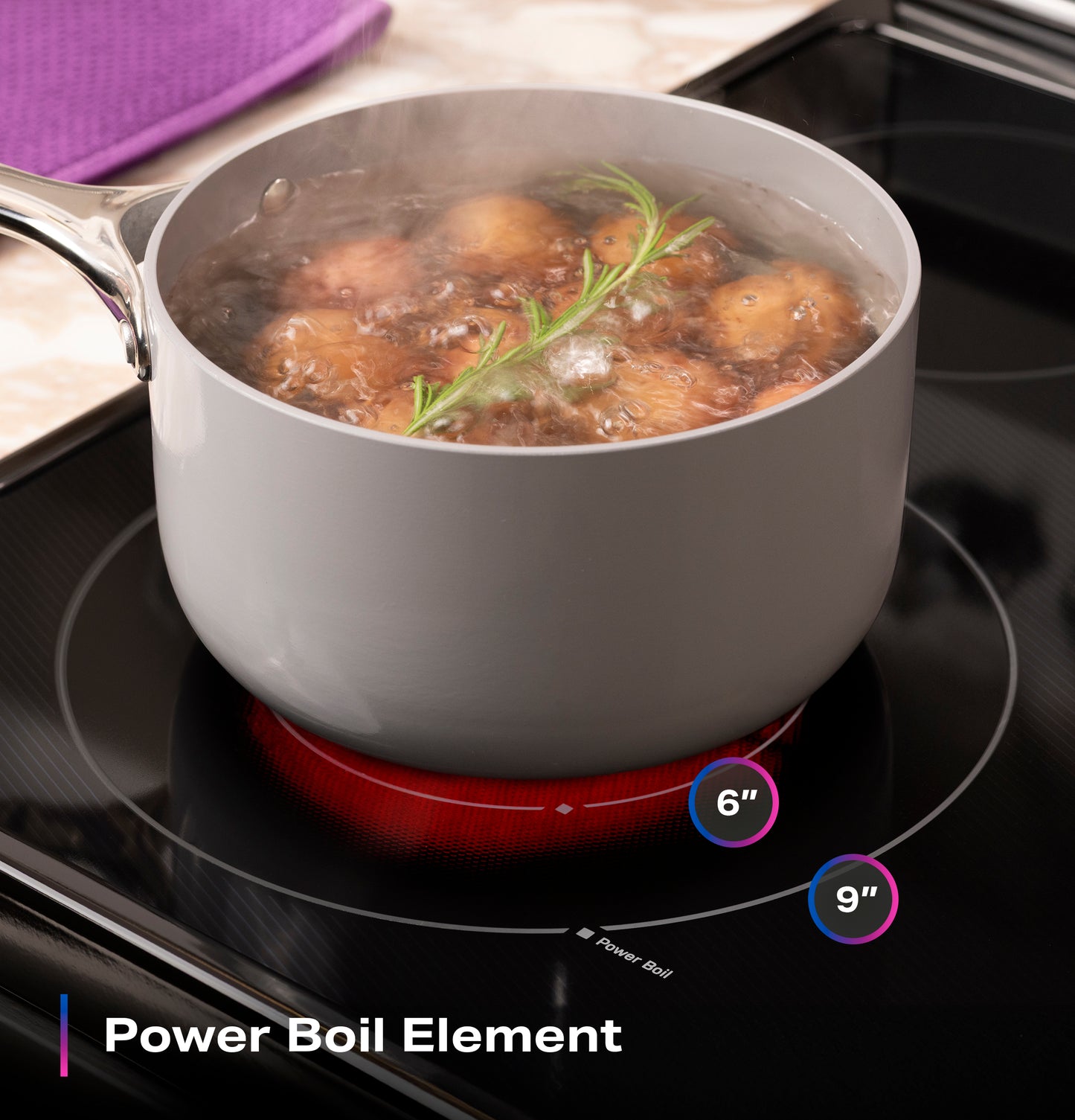 Gray pot boiling potatoes with rosemary on electric induction cooktop with glowing power boil element indicator
