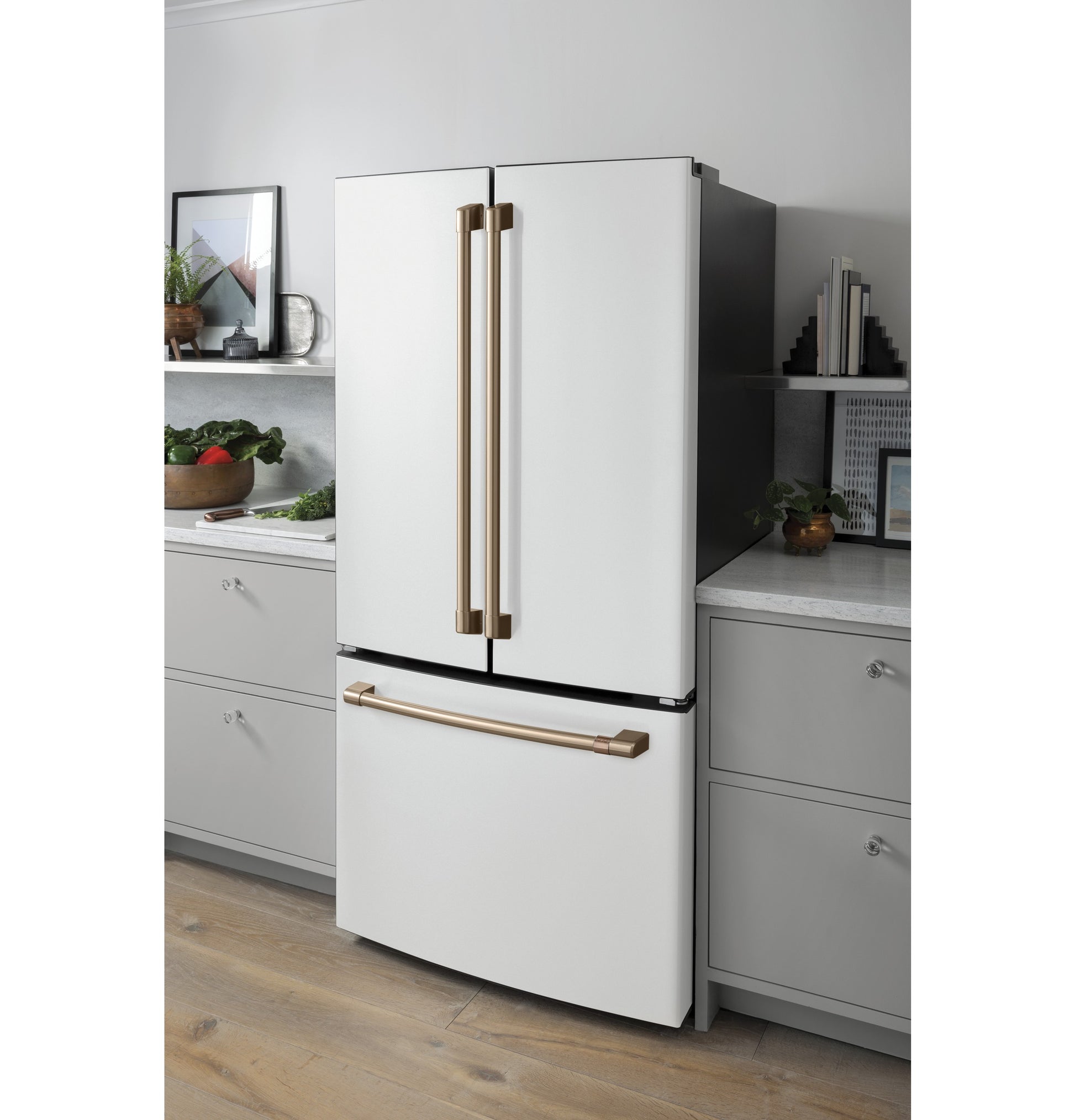 White counter-depth French-door refrigerator with bronze handles and bottom freezer in modern kitchen setting