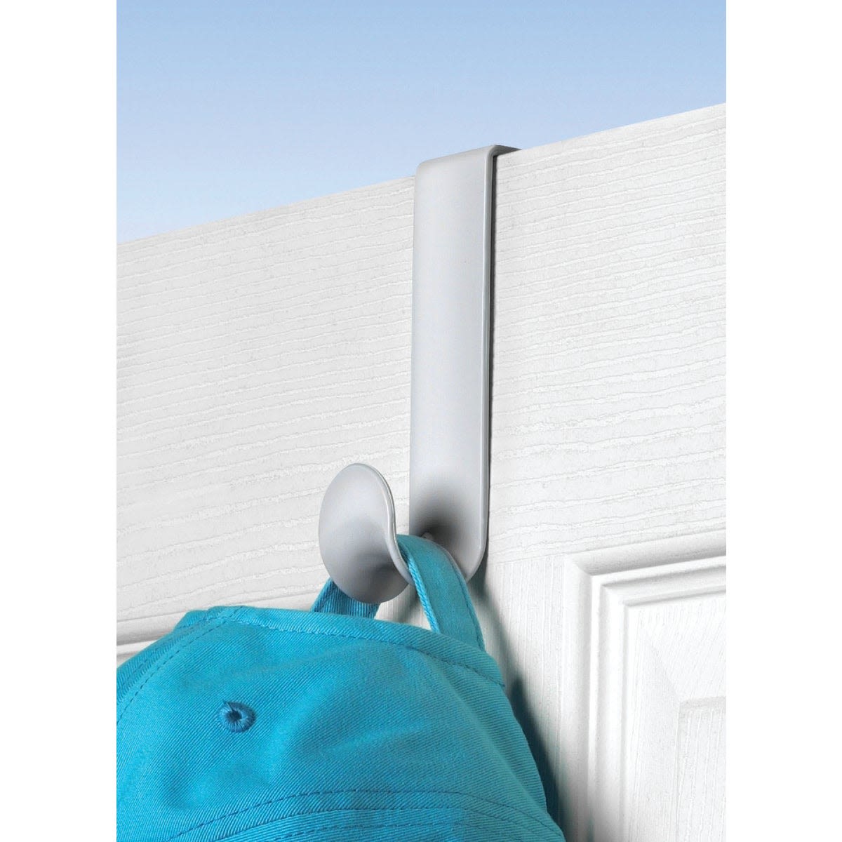 White plastic over-the-door hook holding a blue cap for storage and organization under $25