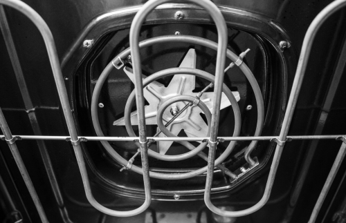 Interior view of oven heating element and metal safety guard inside a kitchen range at Hartville Hardware