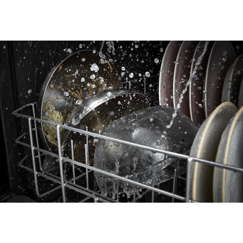 Water spraying inside dishwasher on dirty pots and dishes in kitchen appliance collection for home improvement