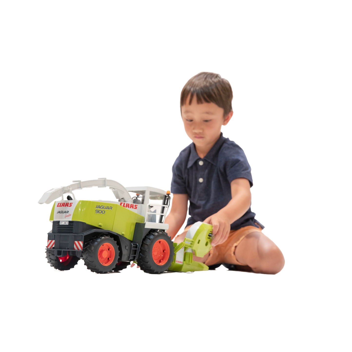 Young child engaging with a detailed Bruder Claas Jaguar 900 Field Chopper toy from Vehicles & Remote Controlled Toys collection