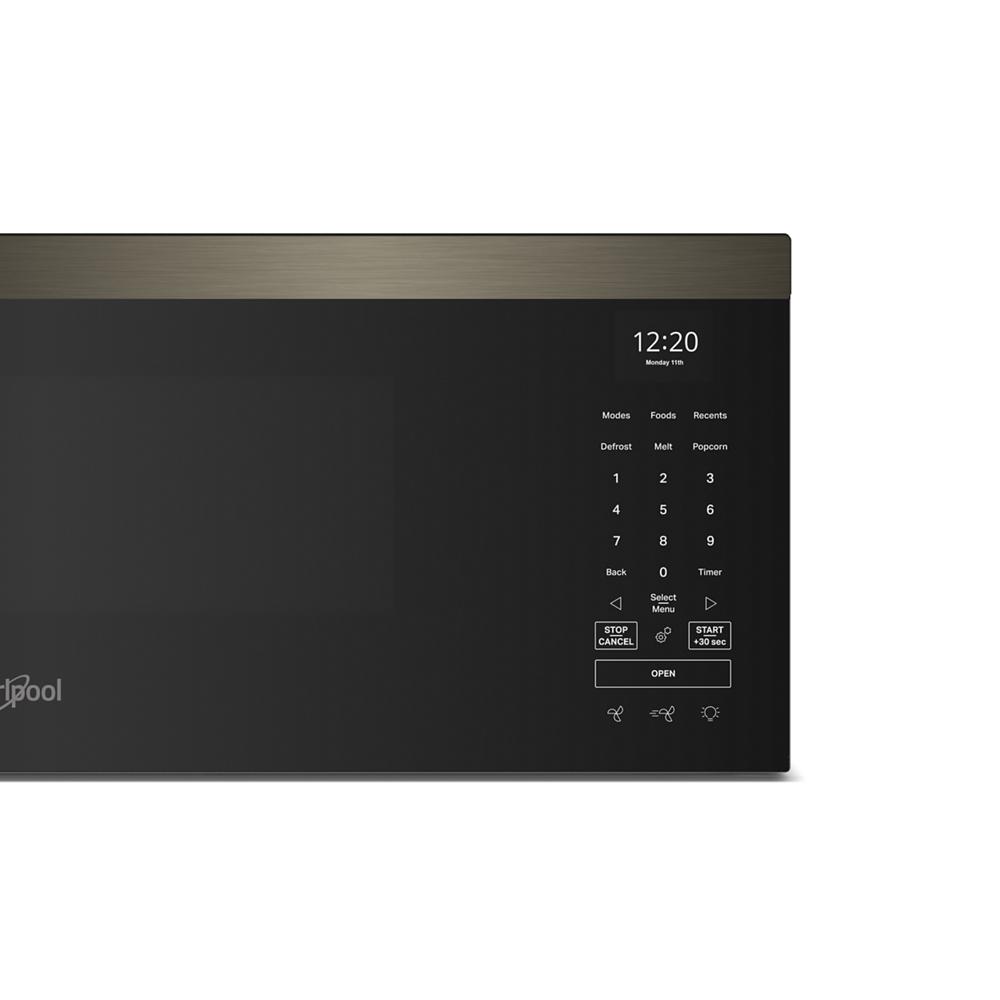 Close-up of black and stainless steel smart microwave control panel with digital clock and touch buttons from kitchen appliances collection