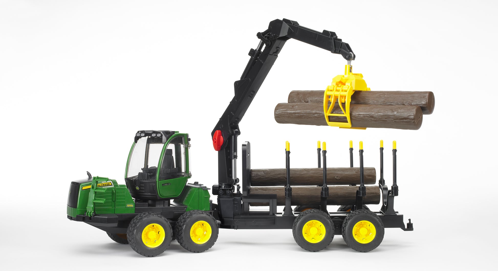 Green and yellow Bruder John Deere 1210E Forwarder toy loading wooden logs with black articulated crane for home improvement play