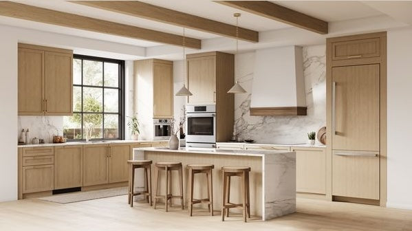Modern kitchen with wood-paneled built-in bottom freezer refrigerator and integrated Bosch appliances collection