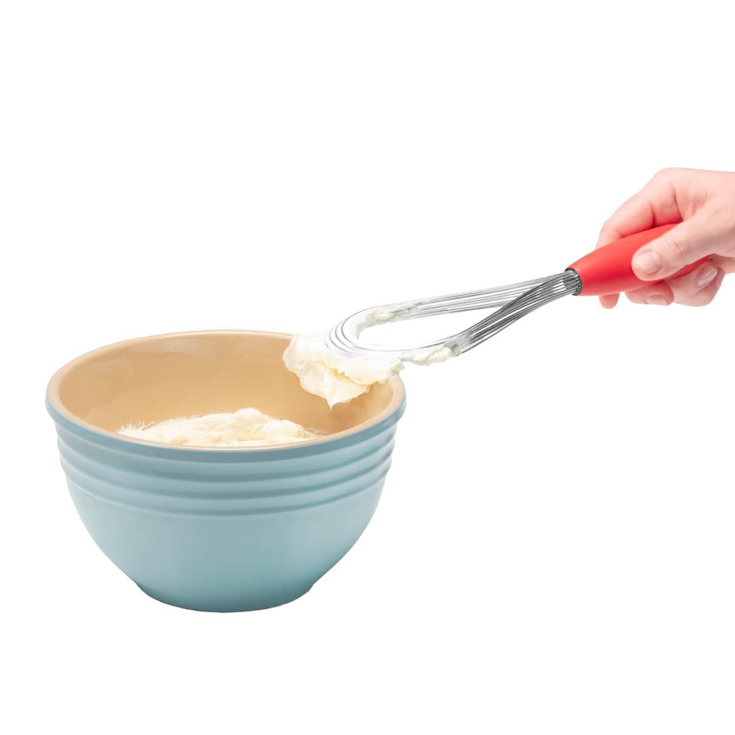 Hand holding red-handled stainless steel flisk lifting whipped cream from blue mixing bowl in kitchen utensils collection