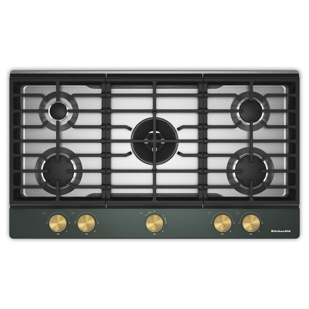 Top view of a 36-inch gas cooktop featuring five burners, an integrated wok grate, and brass-colored control knobs, part of kitchen appliances and gas cooktops for home improvement.
