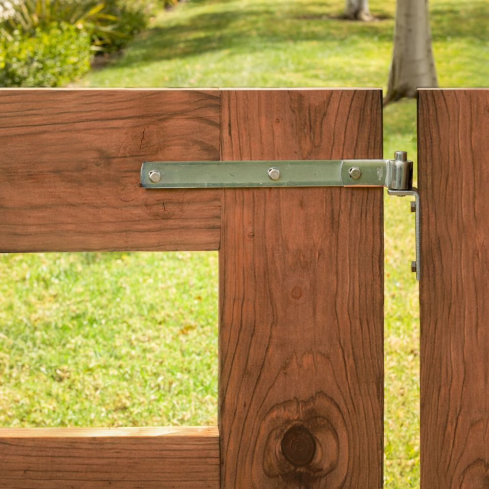 Zinc-plated steel hinge strap attached to wooden gate for durable door and gate hardware in home improvement projects