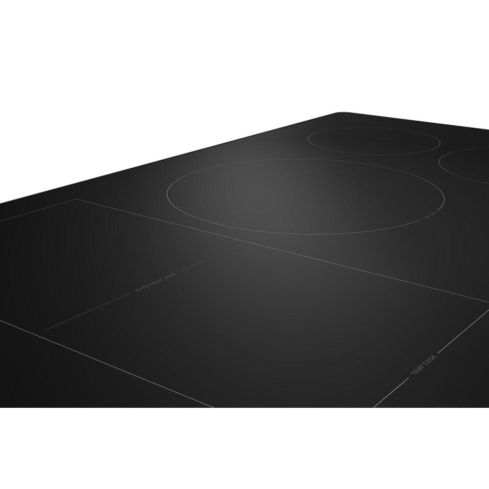 Black glass induction cooktop with five cooking zones designed for precision cooking in KitchenAid appliances collection