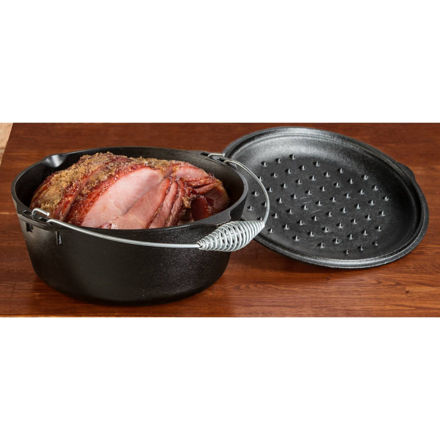 Black cast iron Dutch oven with coil handle and lid designed for slow cooking roasts in Kitchenware collection under $100