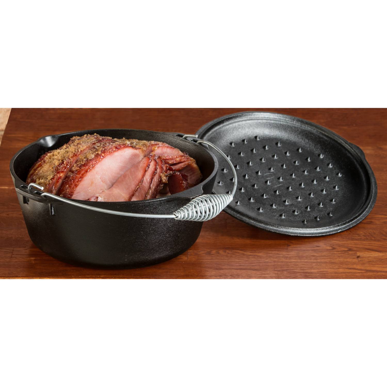Black cast iron Dutch oven with coil handle and lid designed for slow cooking roasts in Kitchenware collection under $100