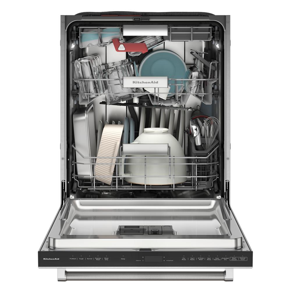 Open KitchenAid dishwasher loaded with dishes, cookware, and utensils in stainless steel interior for kitchenware cleaning.