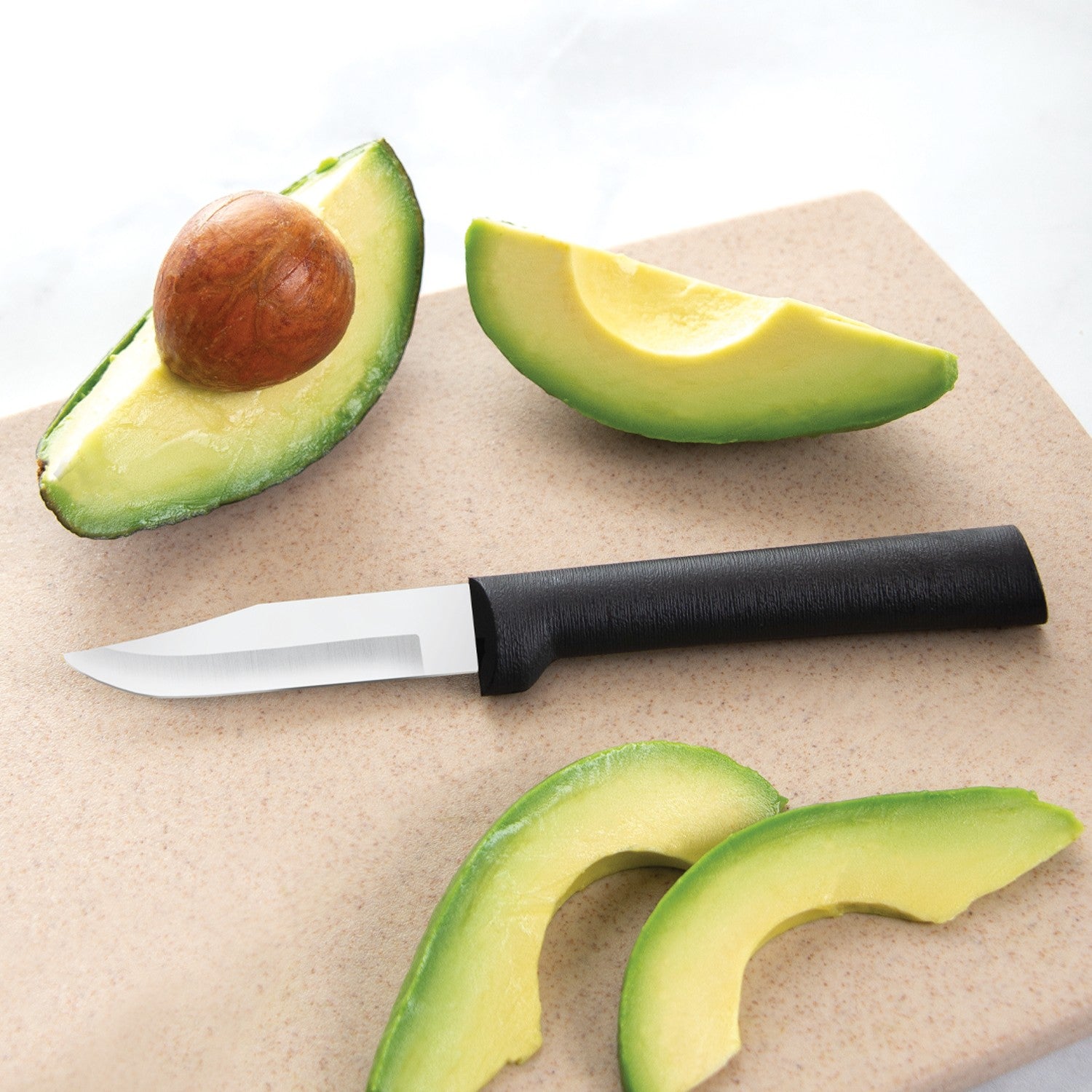 Peeling knife with black handle beside sliced avocado on beige cutting board for precise kitchen prep tasks
