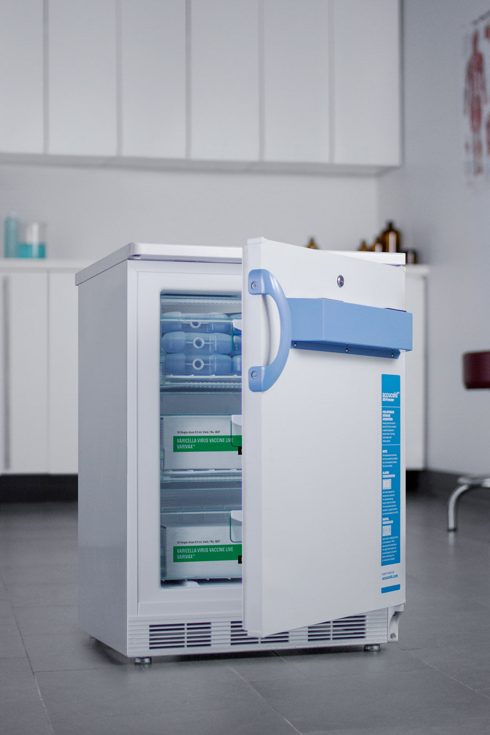 Small built-in freezer with blue handle storing vaccines and medical supplies in lab setting from appliances collection