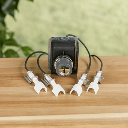 Replacement igniter kit with multiple electrode wires for grill maintenance included in outdoor cooking accessories.