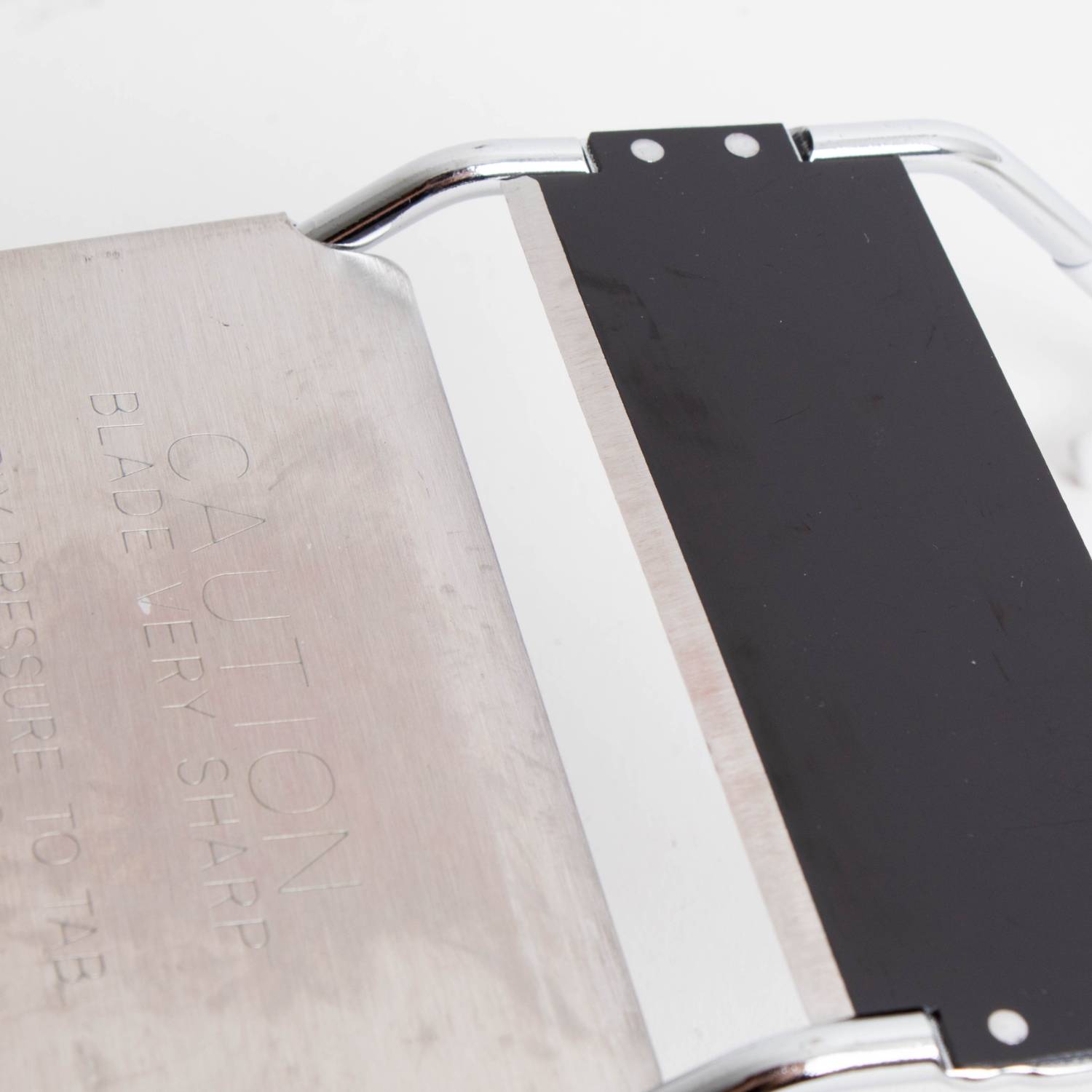 Metal and black plastic vegetable slicer blade with safety warning on kitchenware under $50 collection
