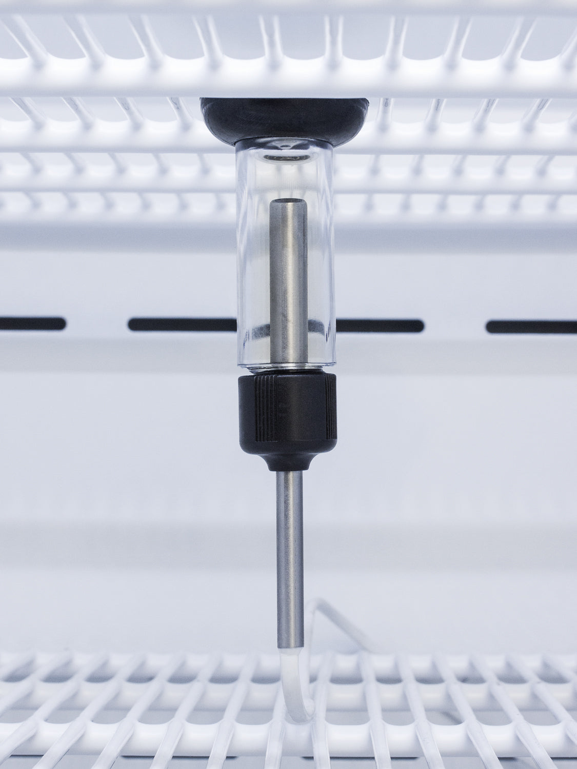 Internal sensor probe attached to white shelving inside a vaccine refrigerator in appliances collection