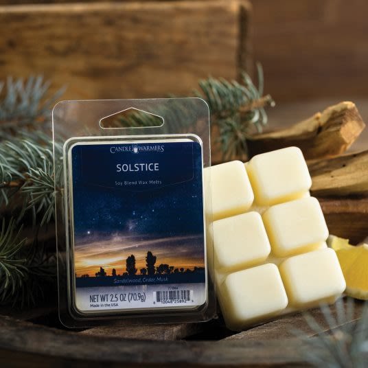 Pack of six creamy wax melts in clear clamshell packaging with natural wood and pine decor for home fragrance and improvement