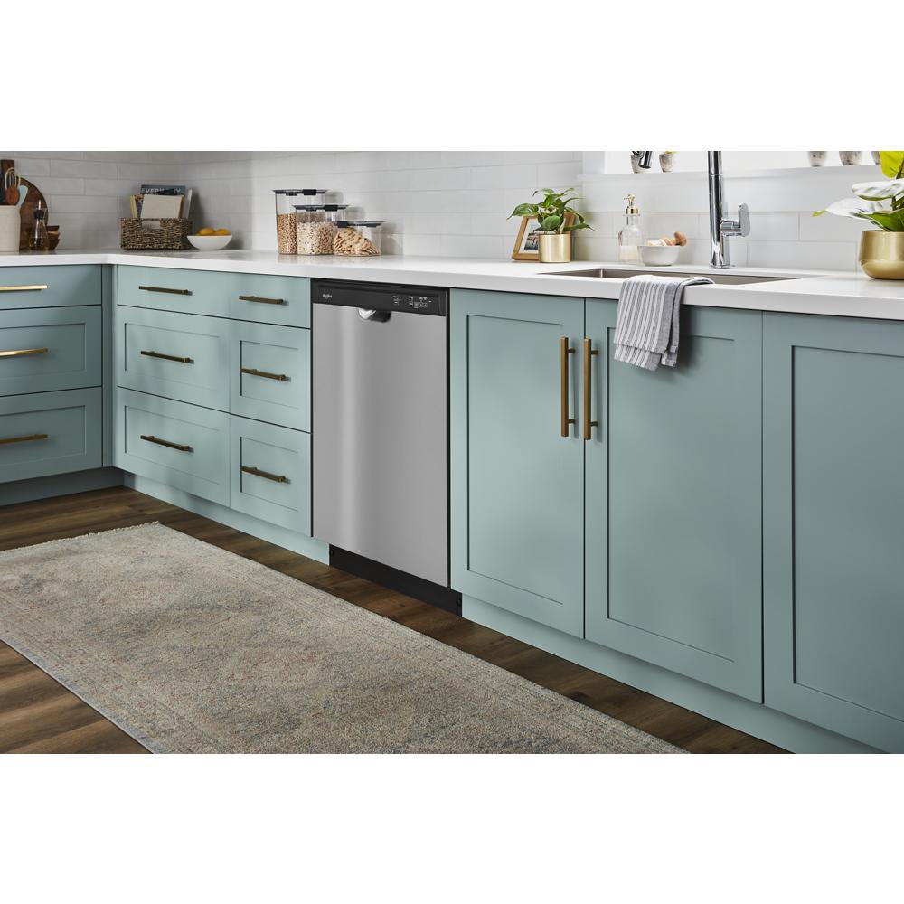 Built-in stainless steel dishwasher integrated into modern kitchen cabinetry with blue-green drawers and brass handles