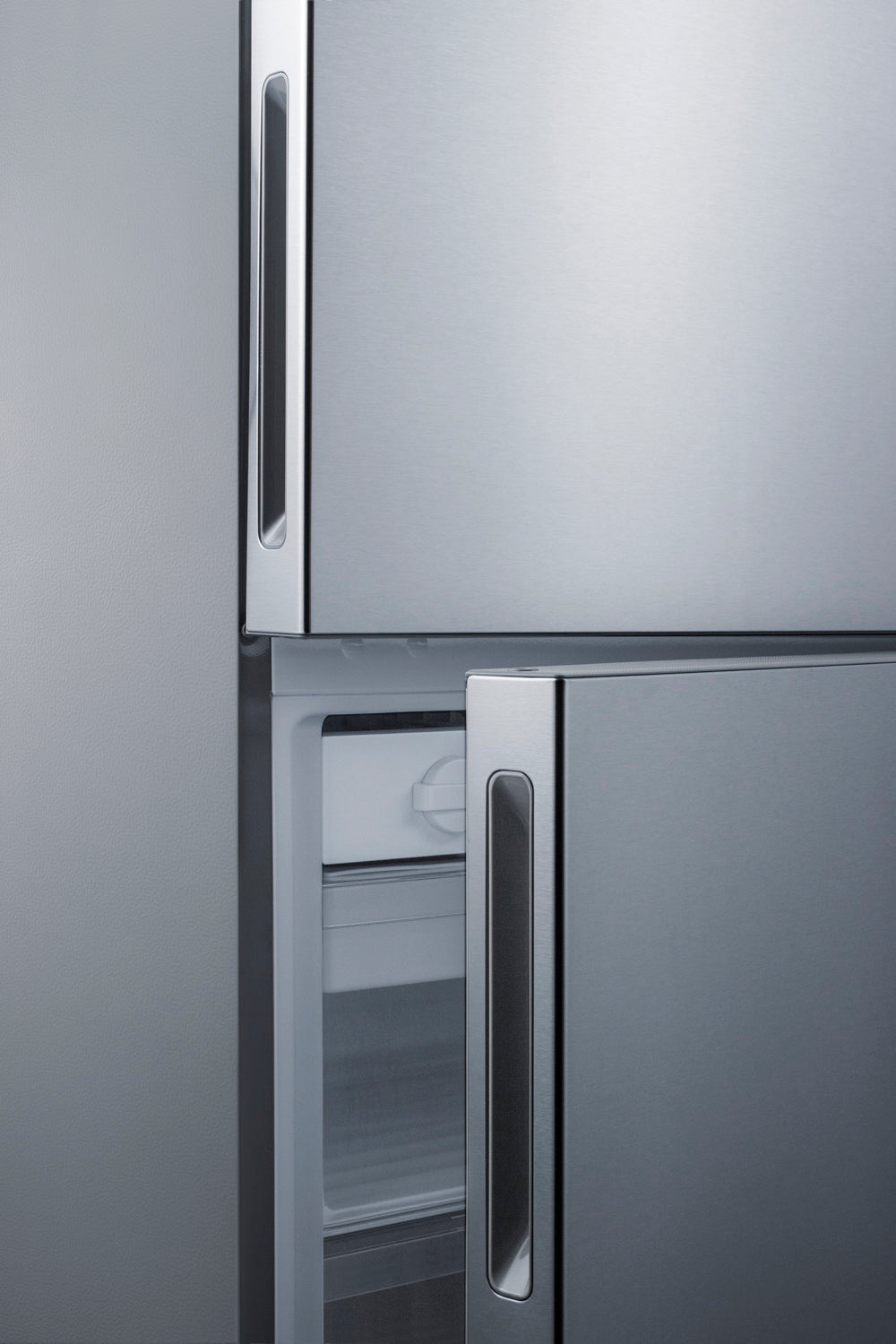 Close-up of stainless steel 28-inch wide bottom freezer refrigerator door handles from Appliances and Kitchen & Kitchenware collections