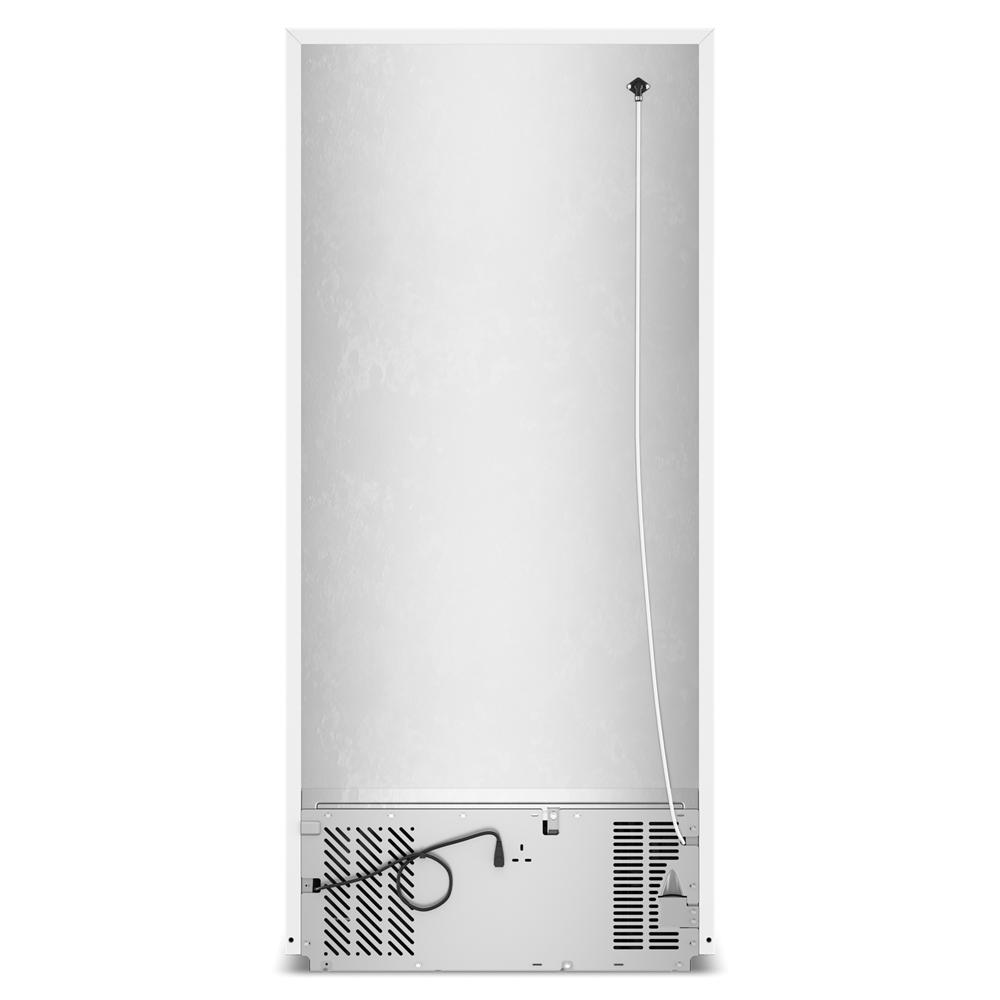 Back view of white top freezer refrigerator showing ventilation, power cord, and appliance connections in kitchen collection