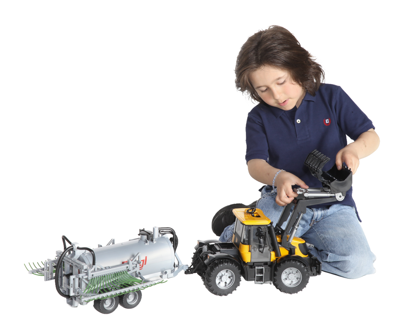 Child playing with Bruder toy tractor pulling barrel trailer with fold-out spread tubes in Vehicles & Remote Controlled Toys collection
