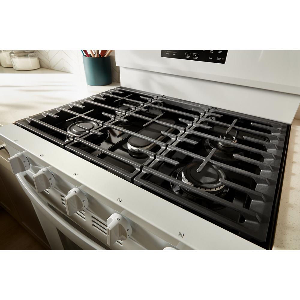white 30-inch gas range with five control knobs and cast-iron grates in kitchen appliances and home improvement collection