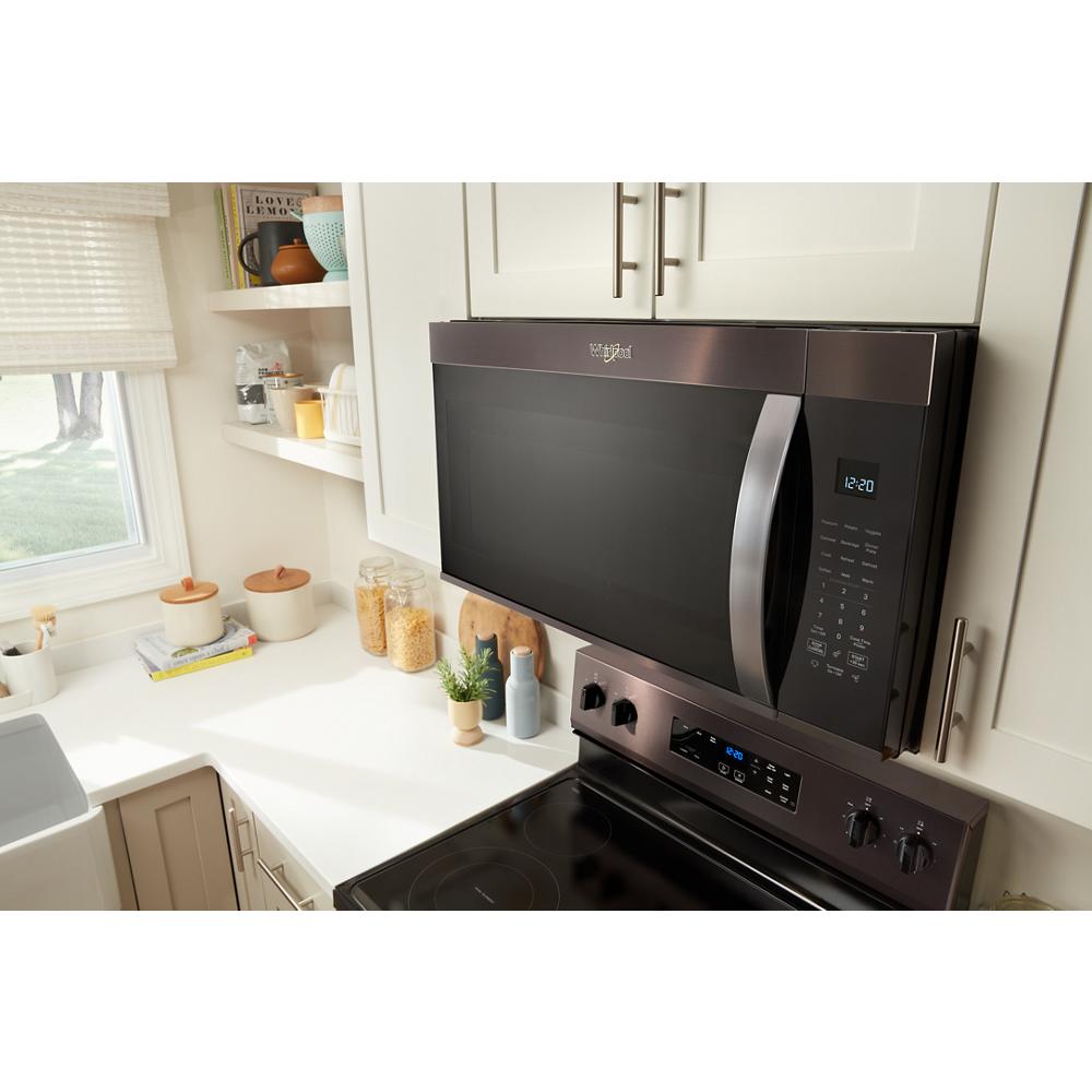 Black stainless steel over the range microwave with sensor cooking controls above electric stove in contemporary kitchen setting